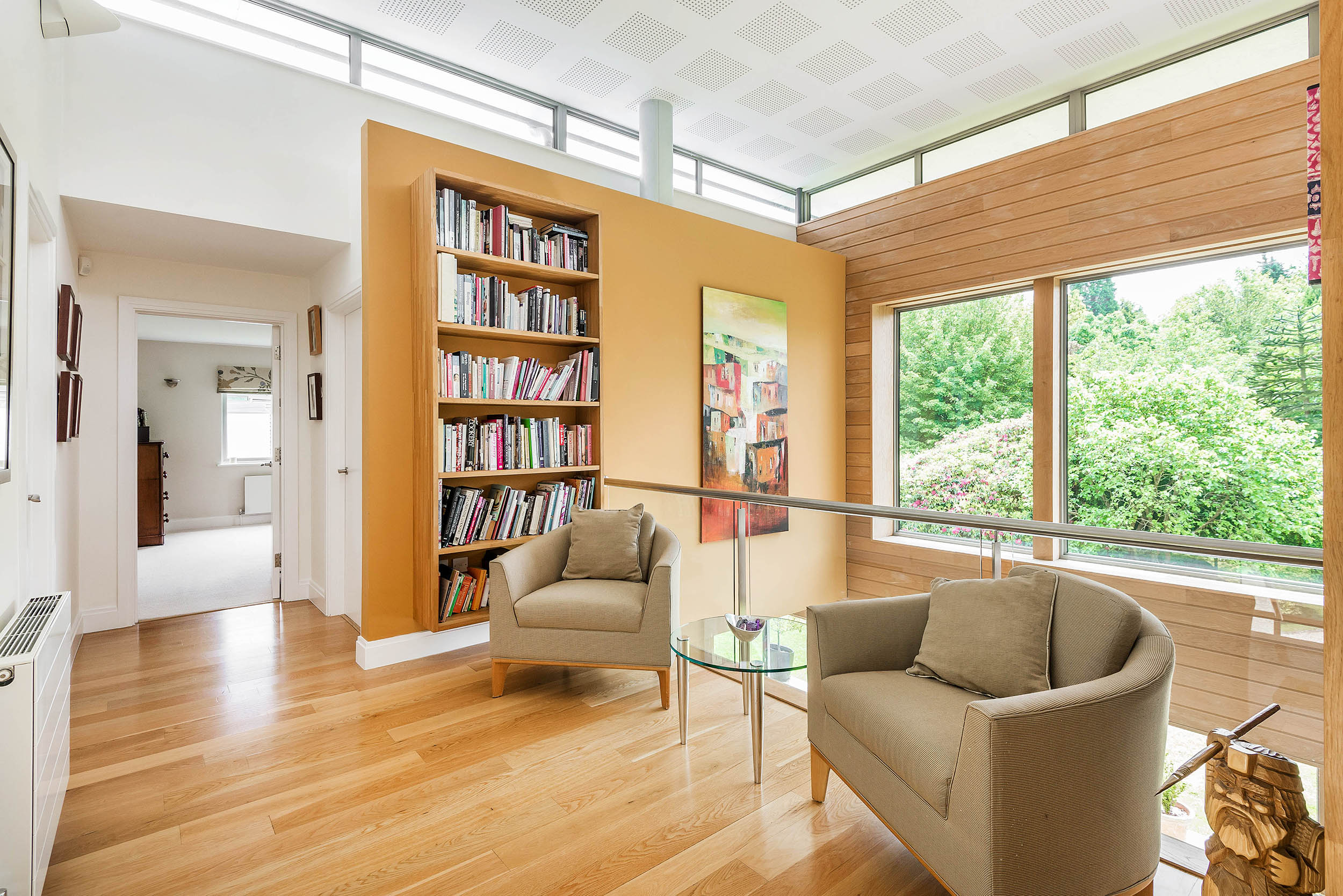 A generous landing provides additional living space with spectacular views from the picture windows out into the garden and also view down into the dining hall below.