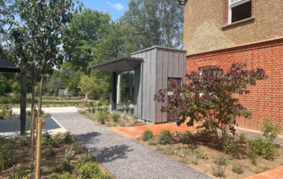 photo of the new extension showing zinc cladding and landscape